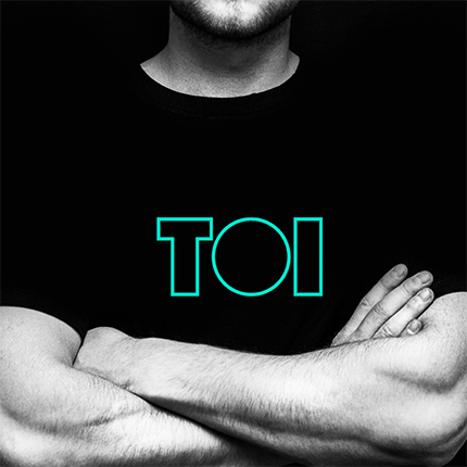Man in TOI branded black shirt with arms folded